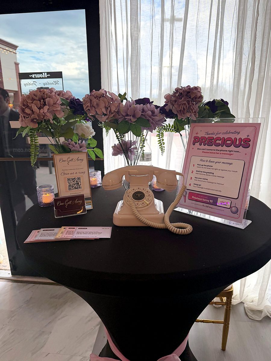 Cocktail table setup with florals and personalized sign at a birthday