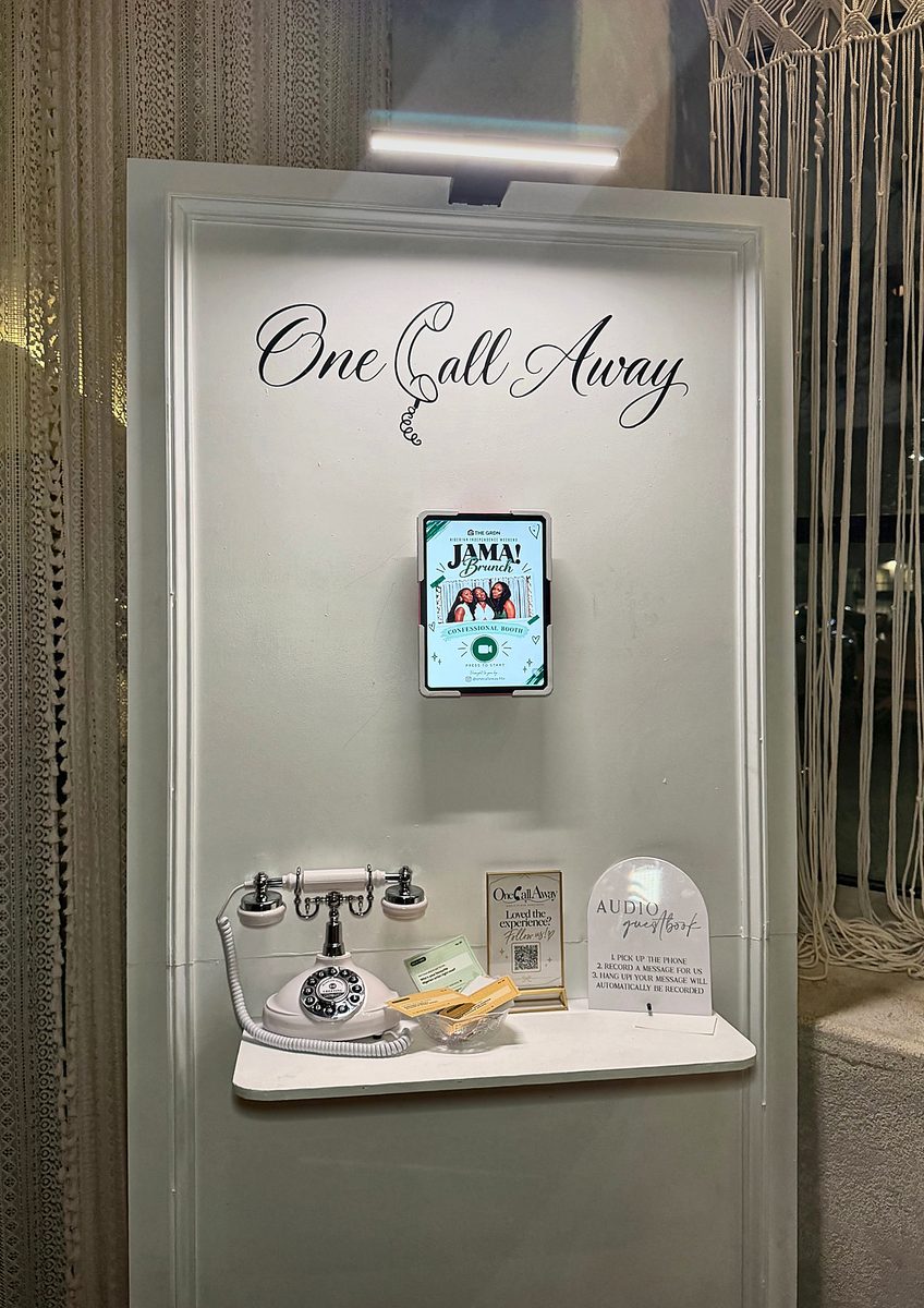Signature board with confessional booth video station at a brunch